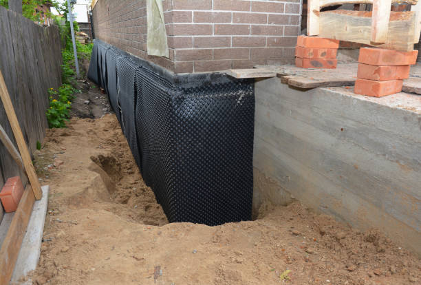 SJ Waterproofing Pros technician performing targeted Interior Drainage System assessment in Valley Center, KS